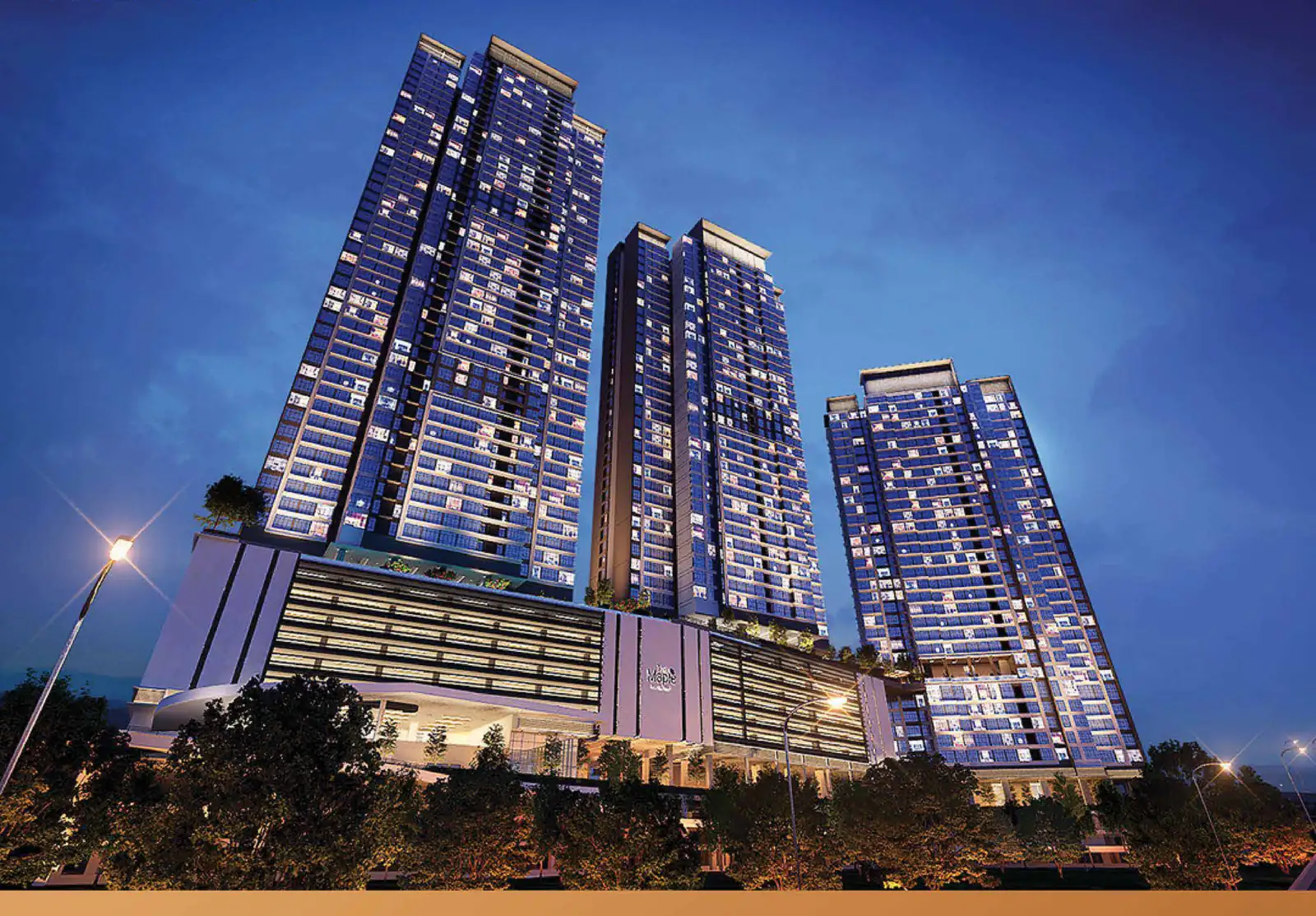The Maple Residences three towers lit at blue hour above a linear podium at WCity OUG, Kuala Lumpur